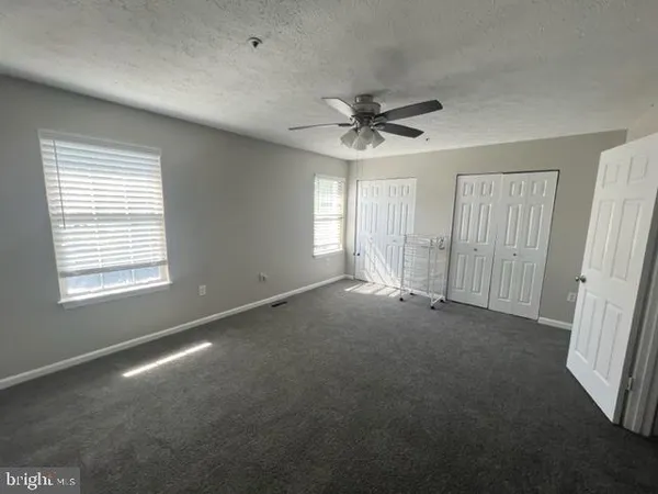 a view of a livingroom with a ceiling fan and window