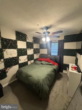 a bed sitting in a bedroom next to a lamp