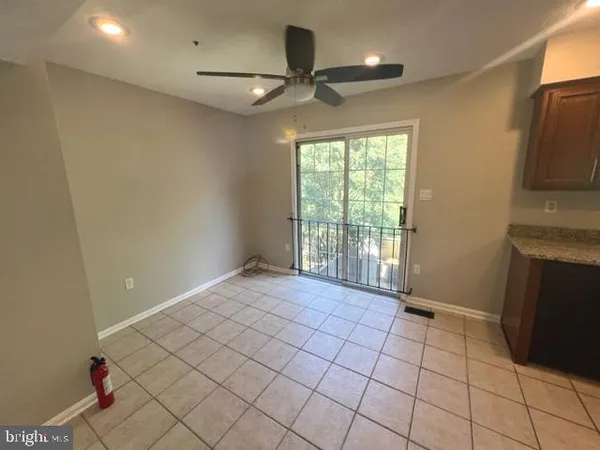 a view of an empty room with a fireplace and a window