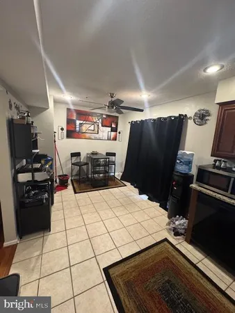 a kitchen with a refrigerator and a stove top oven