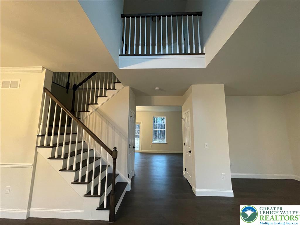 777 Adams Road Breinigsville, PA 18031 - Photo 2 of 24 a view of staircase with wooden floor and white walls