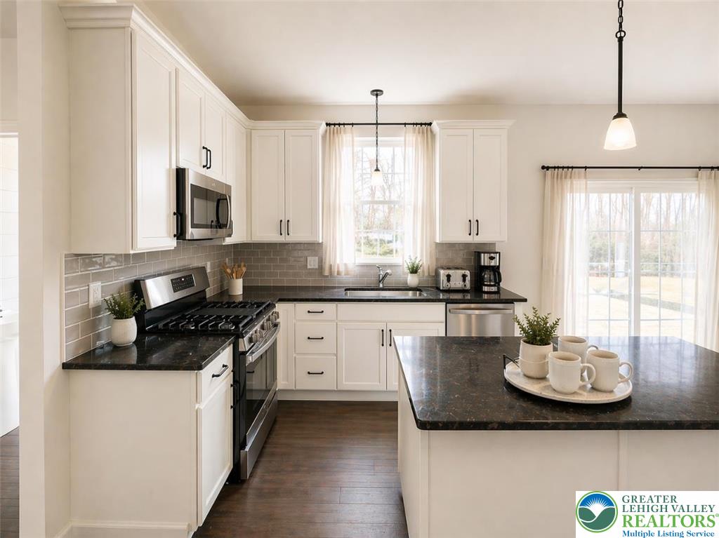 777 Adams Road Breinigsville, PA 18031 - Photo 3 of 24 a kitchen with a sink stove and microwave