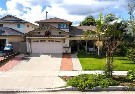 a front view of a house with a yard and potted plants