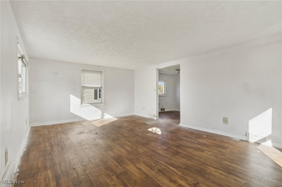 1733 Ronald Road Akron, OH 44312 - Photo 3 of 33 Unfurnished living room with dark wood-type flooring and a textured ceiling