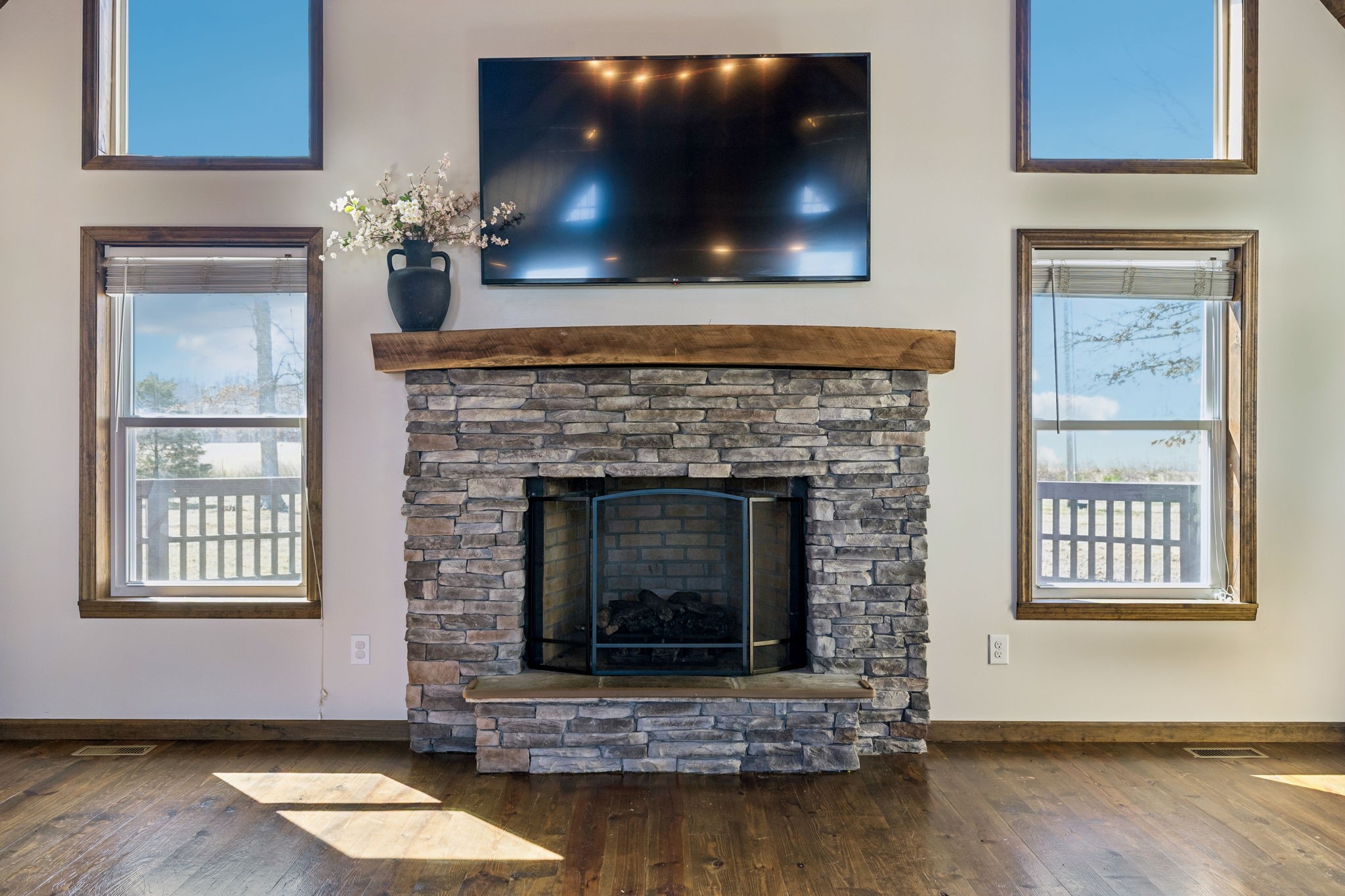267 Switzerland Road Hohenwald, TN 38462 - Photo 35 of 98 a living room with a fireplace and a flat screen tv