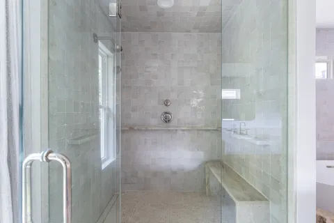 a bathroom with a glass shower door