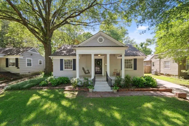 a front view of a house with a yard and porch
