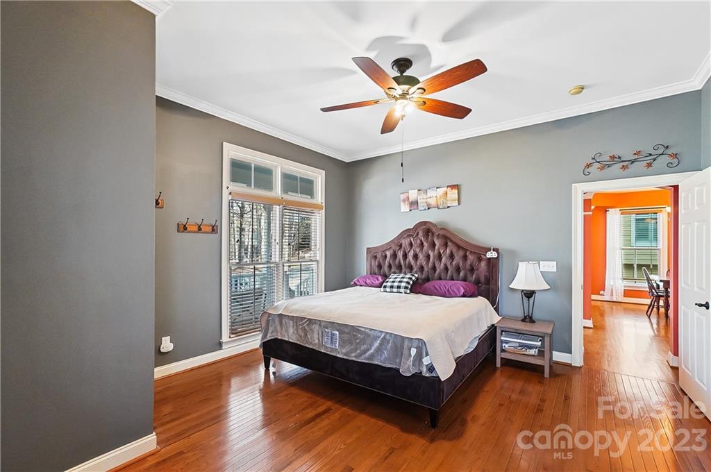 2557 Lower Assembly Drive Fort Mill, SC 29708 - Photo 20 of 32 a bedroom with a large bed and a chandelier