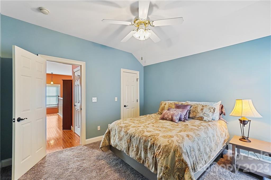 2557 Lower Assembly Drive Fort Mill, SC 29708 - Photo 24 of 32 a bedroom with a bed and a chandelier