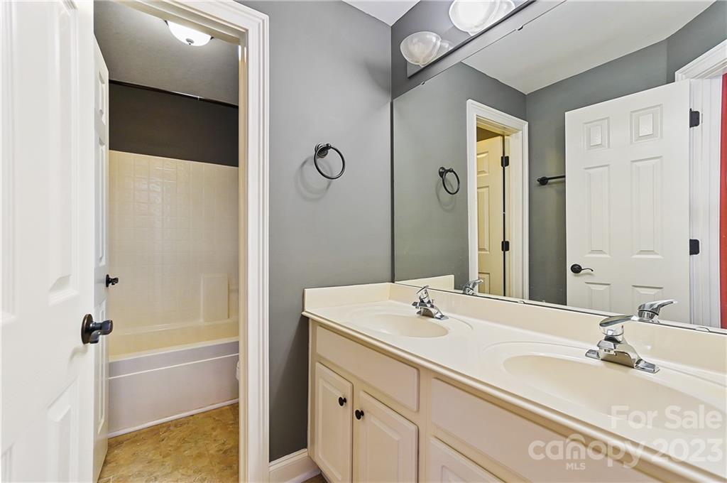 2557 Lower Assembly Drive Fort Mill, SC 29708 - Photo 26 of 32 a bathroom with a granite countertop sink and a mirror