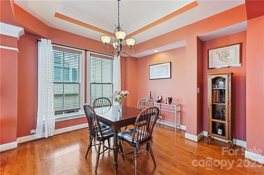 2557 Lower Assembly Drive Fort Mill, SC 29708 - Photo 6 of 32 a dining room with furniture a chandelier and wooden floor