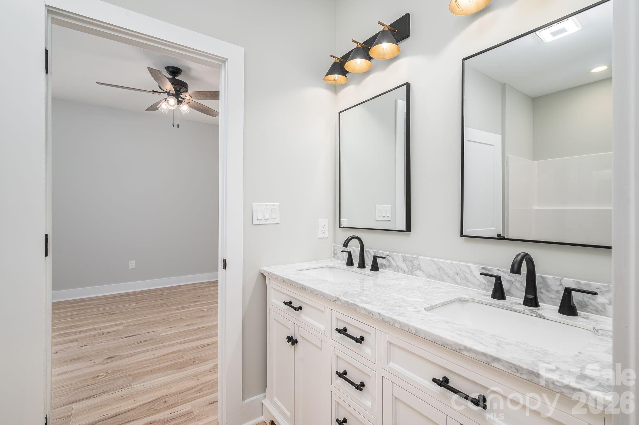 2474 Shoal Road Crouse, NC 28033 - Photo 23 of 39 a bathroom with double vanity sink and a mirror