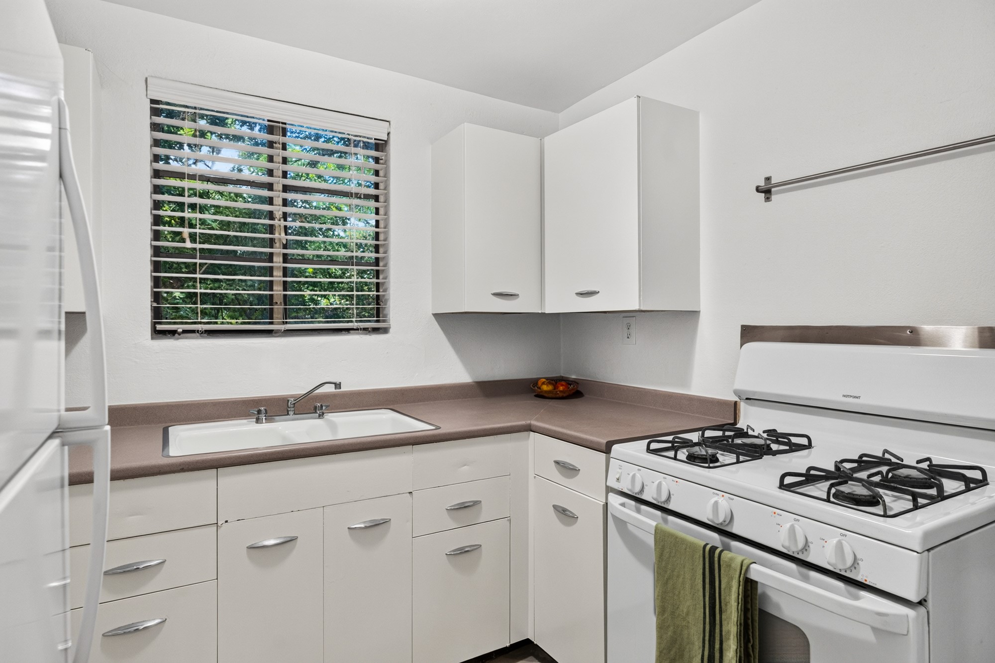 1302 Kirkwood Road, Unit B Austin, TX 78722 - Photo 12 of 21 A well-equipped kitchen features a gas range and ample cabinetry, offering functional culinary space.