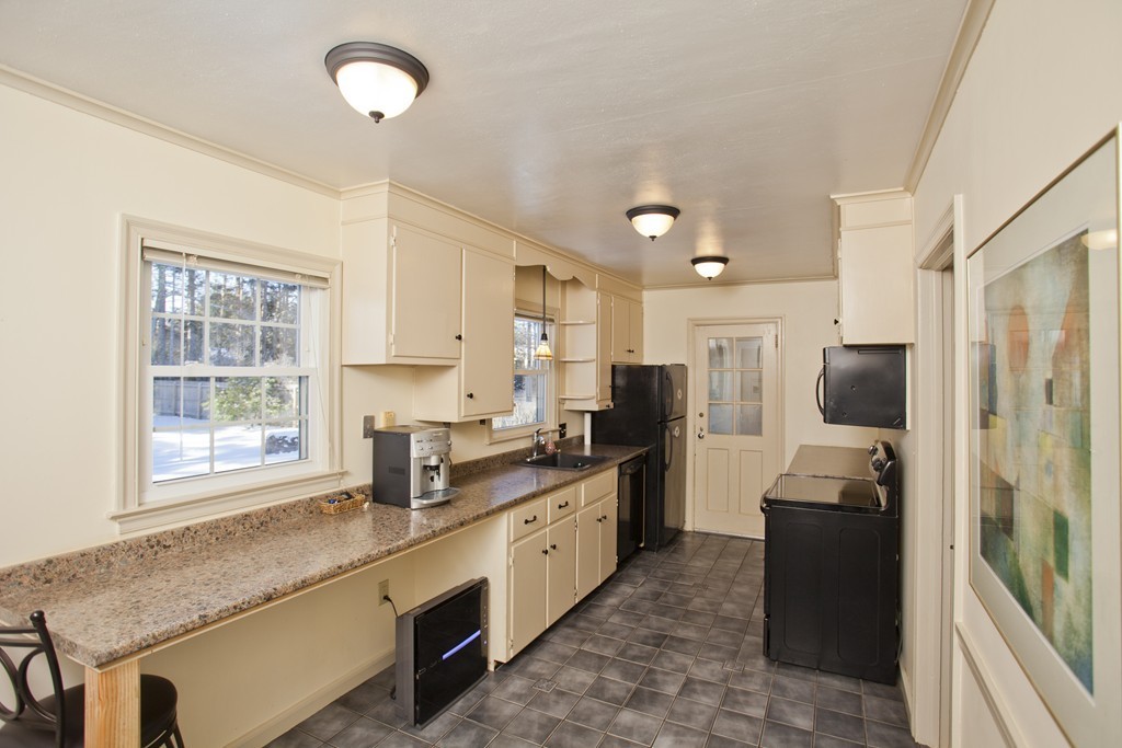 6 Colonial Road Wilbraham, MA 01095 - Photo 5 of 17 a large kitchen with kitchen island granite countertop a refrigerator stove microwave and sink