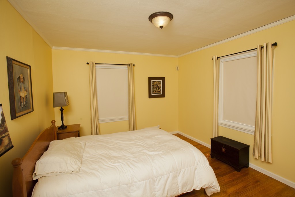 6 Colonial Road Wilbraham, MA 01095 - Photo 7 of 17 a bedroom with a bed and wooden floor
