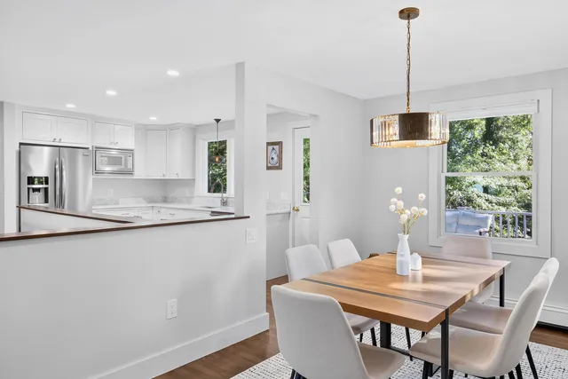 a view of a dining room with furniture window and wooden floor