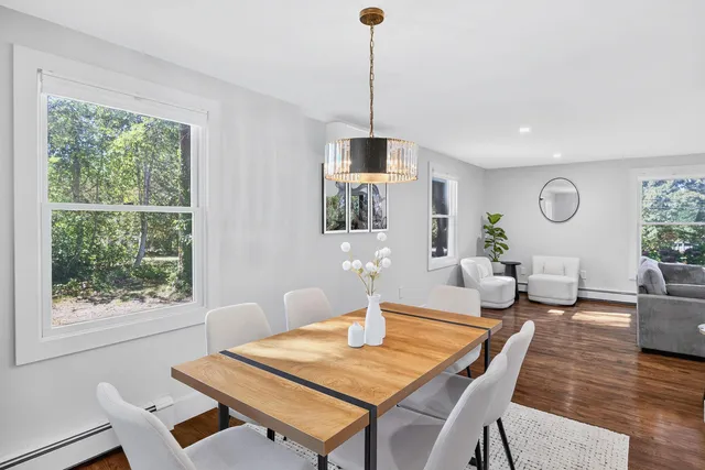a view of a dining room with furniture window and wooden floor