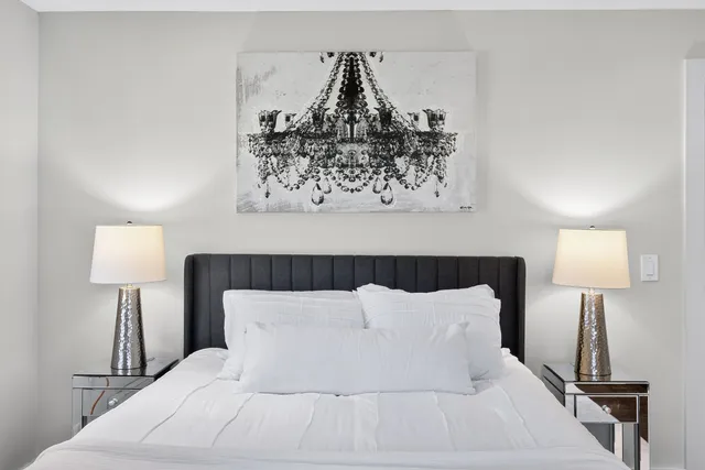 a bedroom with a bed and a lamp