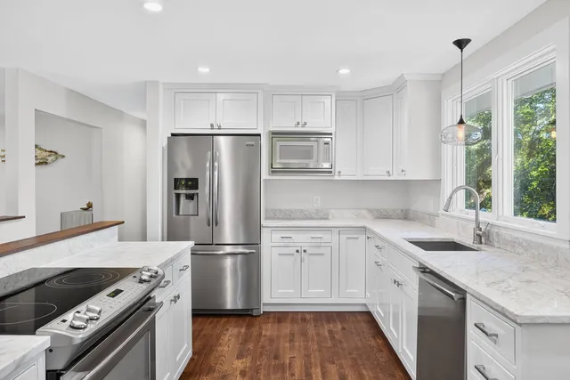 a kitchen with a sink stove and refrigerator