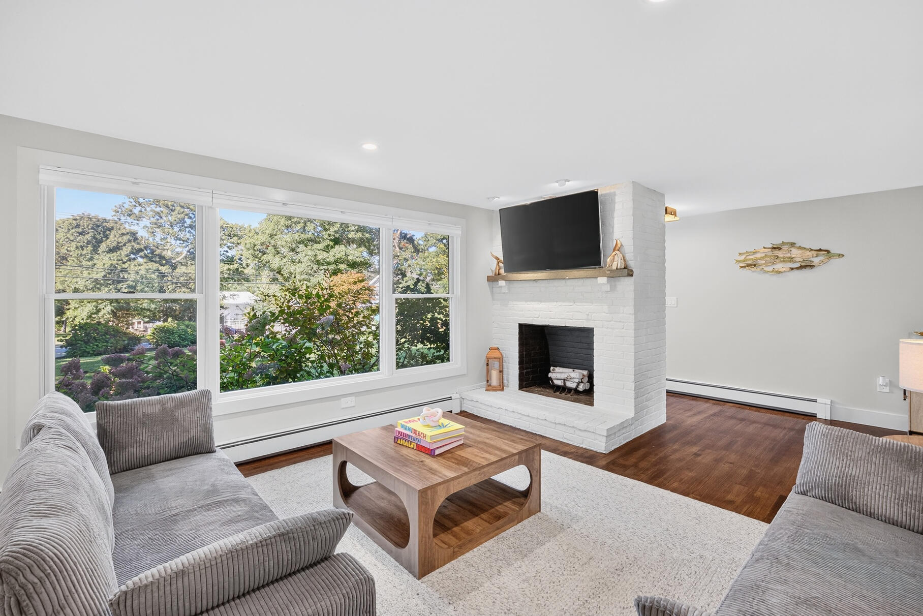 95 South Orleans Road Orleans, MA 02653 - Photo 6 of 38 a living room with furniture a flat screen tv and a fireplace