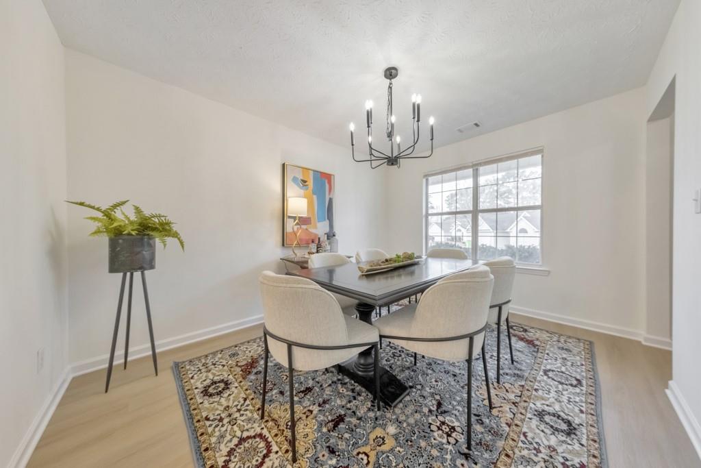 334 Fallview Drive McDonough, GA 30253 - Photo 11 of 34 a view of a dining room with furniture window and wooden floor