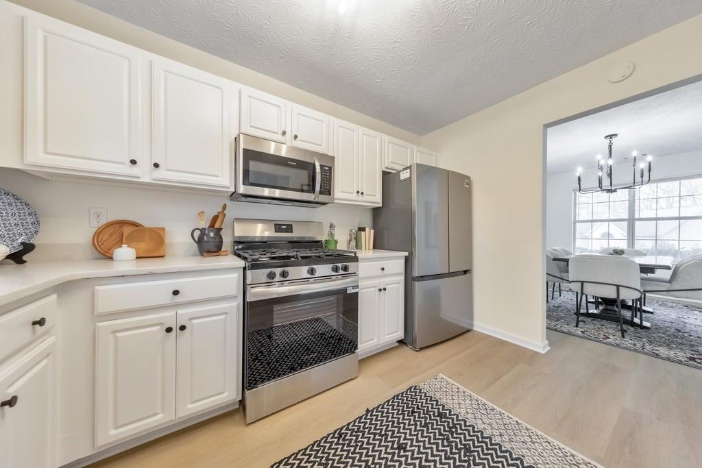 334 Fallview Drive McDonough, GA 30253 - Photo 13 of 34 a kitchen with stainless steel appliances a stove a sink and a refrigerator