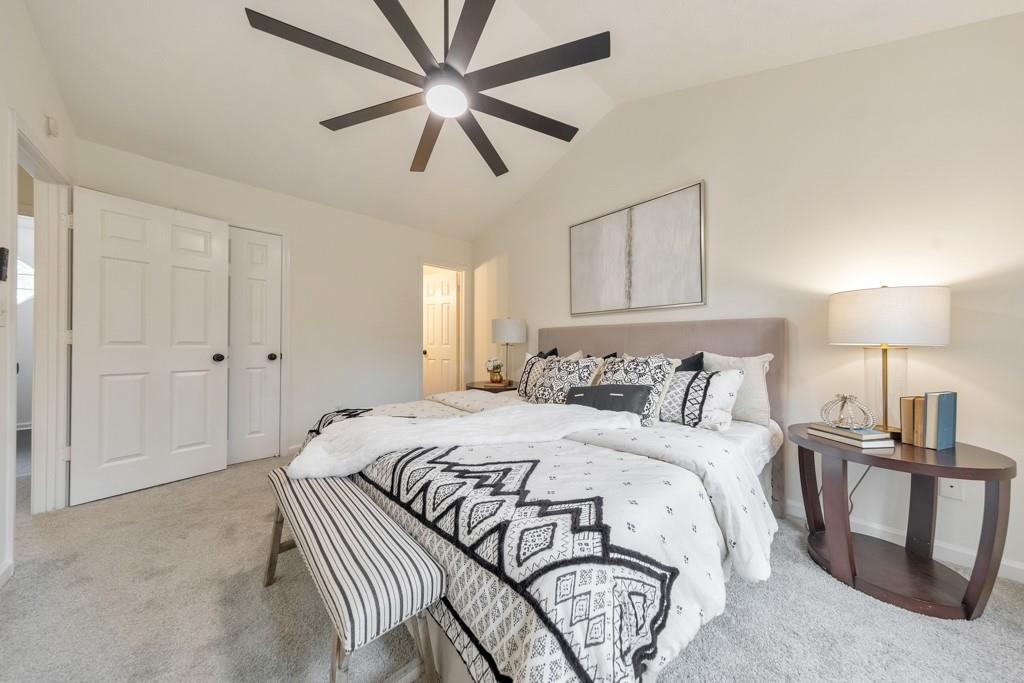 334 Fallview Drive McDonough, GA 30253 - Photo 19 of 34 a bedroom with a large bed and a chandelier