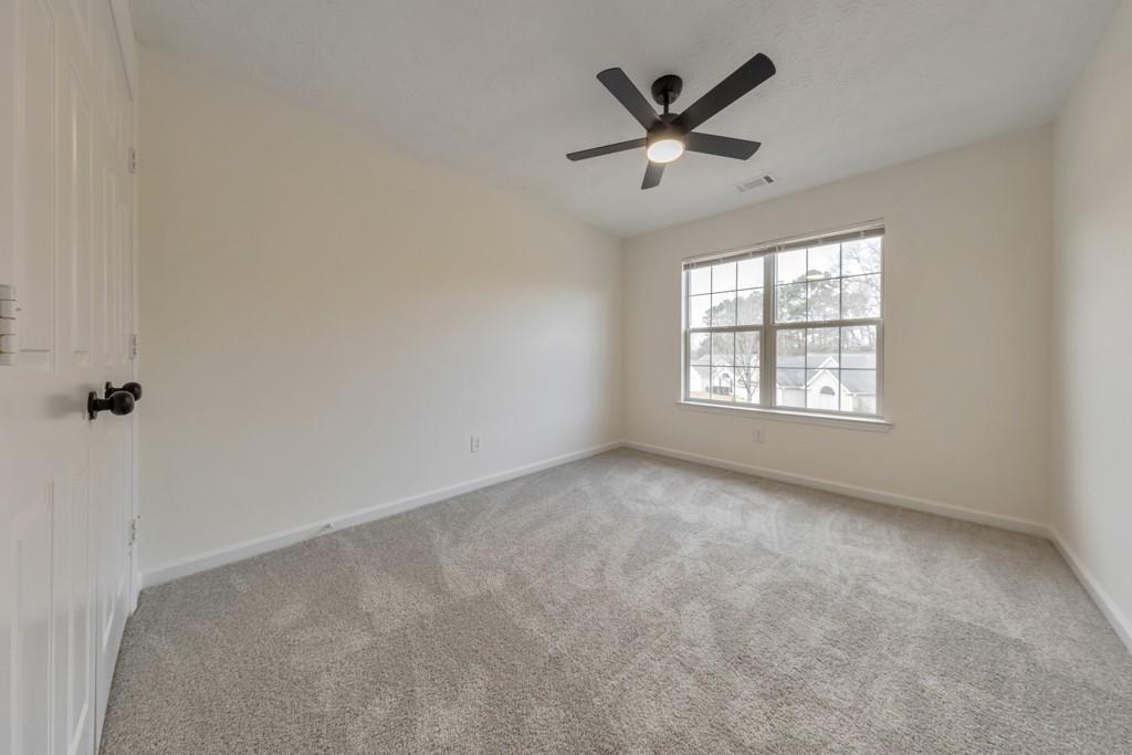 334 Fallview Drive McDonough, GA 30253 - Photo 22 of 34 an empty room with ceiling fan and windows