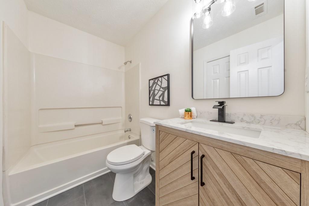 334 Fallview Drive McDonough, GA 30253 - Photo 24 of 34 a bathroom with a sink a toilet and shower