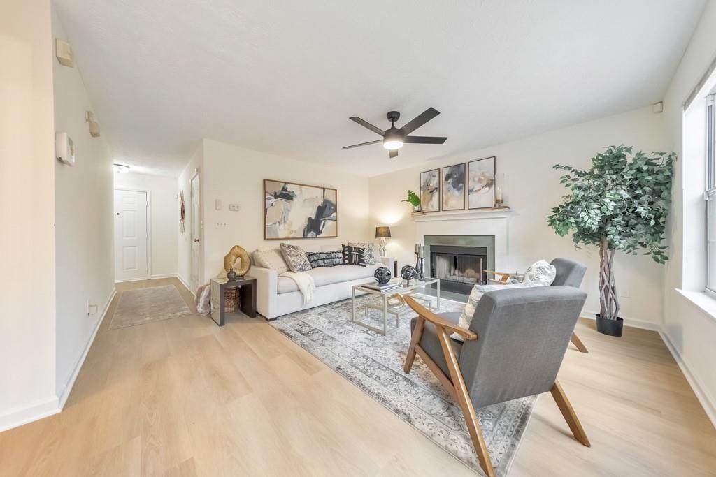 334 Fallview Drive McDonough, GA 30253 - Photo 3 of 34 a living room with furniture a fireplace and a potted plant