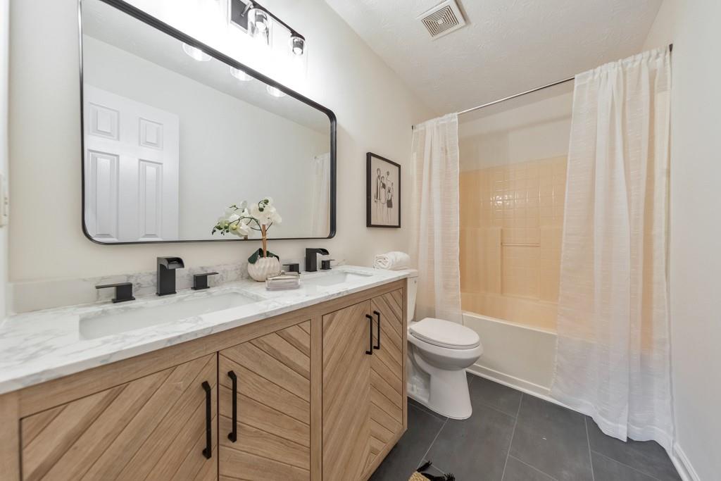 334 Fallview Drive McDonough, GA 30253 - Photo 5 of 34 a bathroom with a double vanity sink and a mirror