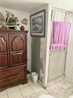 a bedroom with a bed and dresser with mirror