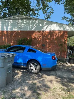 a view of a back yard of the house with a yard