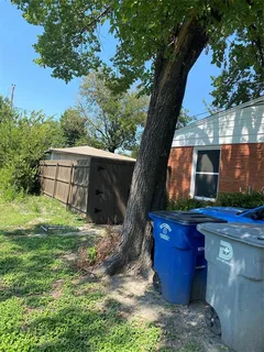 a view of a backyard with plants and a patio