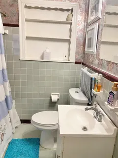 a bedroom with bed and wall painting