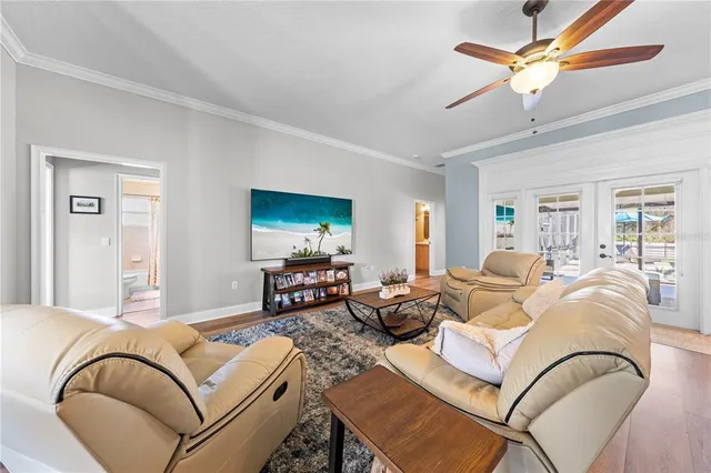 a living room with furniture a flat screen tv and a large window
