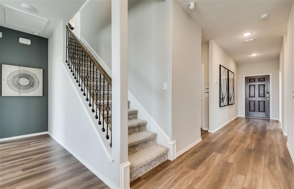 7509 Bent Gale Road Pilot Point, TX 76258 - Photo 2 of 26 a view of a hallway view with wooden floor and staircase