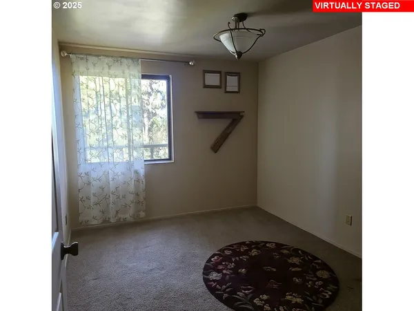 a view of room with a ceiling fan and window
