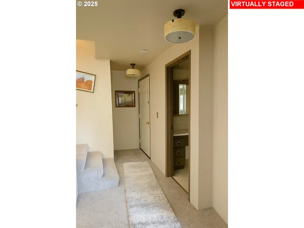 a view of a bathroom with a sink and a mirror
