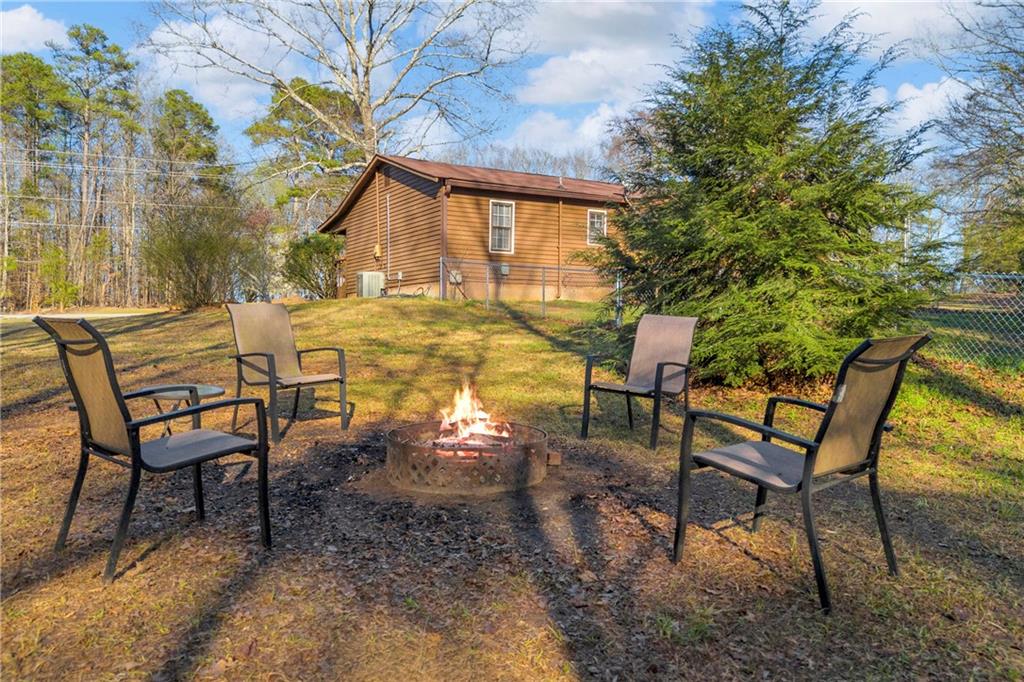 1019 White Hill School Road Commerce, GA 30529 - Photo 20 of 53 a view of a chairs and table in backyard