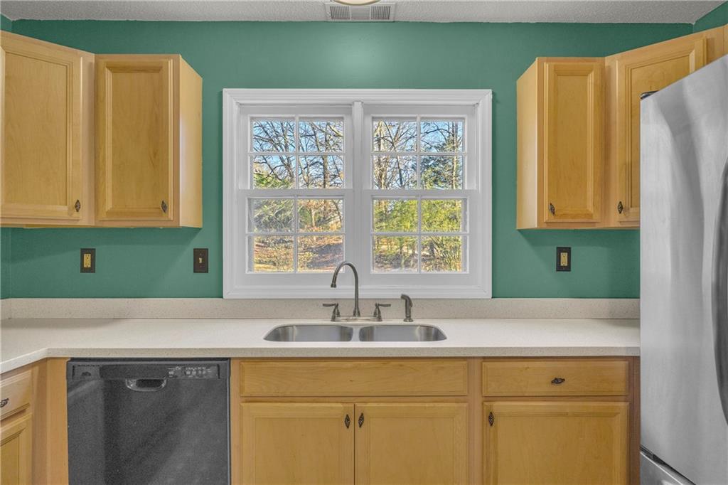 1019 White Hill School Road Commerce, GA 30529 - Photo 38 of 53 a view with kitchen island a sink a window and a cabinet