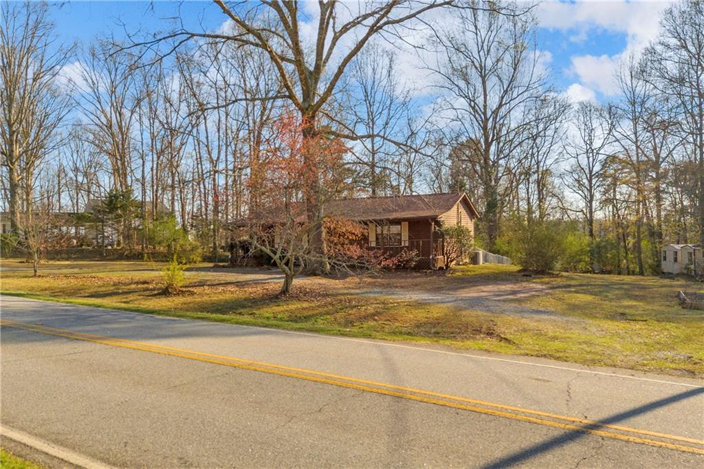 1019 White Hill School Road Commerce, GA 30529 - Photo 4 of 53 a view of a house with a yard and a large tree