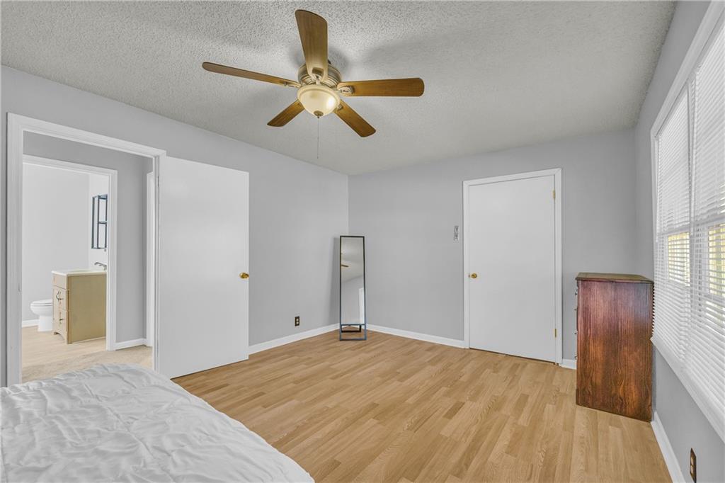 1019 White Hill School Road Commerce, GA 30529 - Photo 45 of 53 a bedroom with a bed and a chandelier