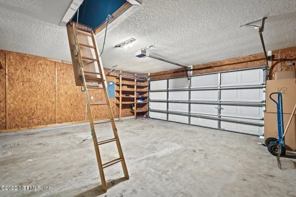 a view of an empty room and fire place