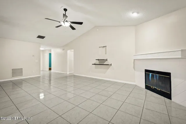 a kitchen with granite countertop a refrigerator and a stove top oven