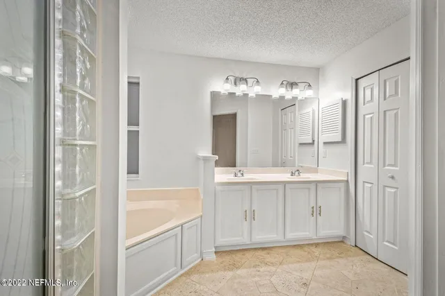 a view of bathroom with dual sinks
