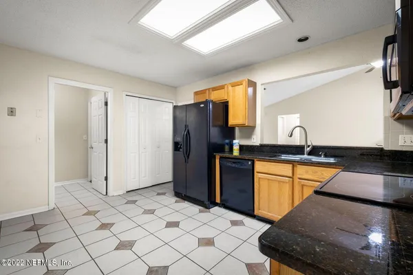 a kitchen with stainless steel appliances granite countertop a refrigerator and a sink