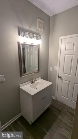 a view of small space with racks on the wall and a window