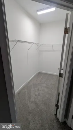 a white toilet sitting next to a shower
