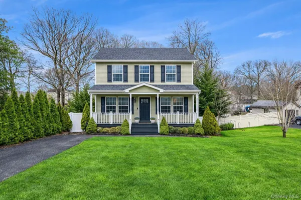 a front view of a house with a yard porch and sitting area